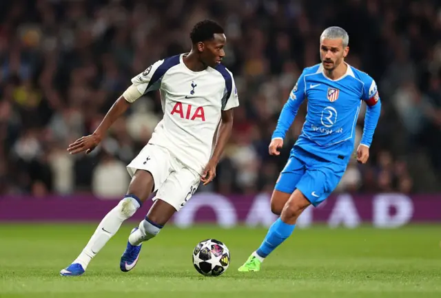 pape matar sarr playing for tottenham under pressure from antonio griezmann