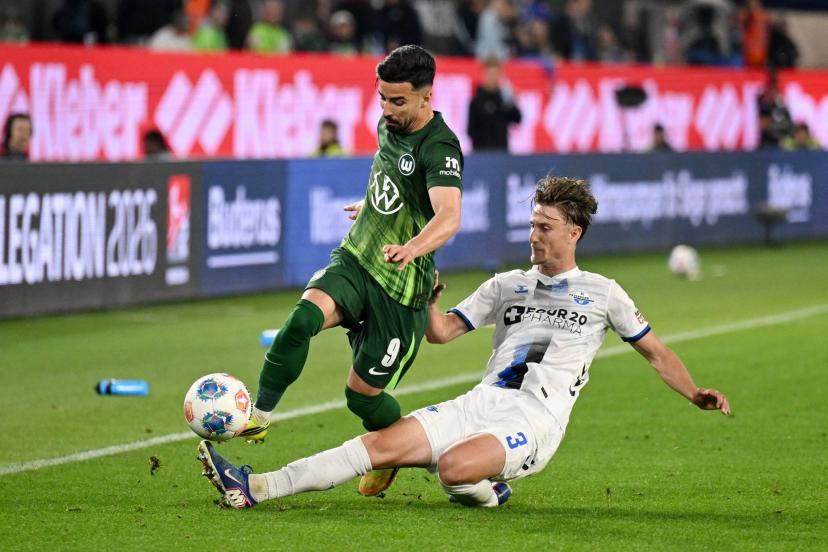 Wolfsburg and Paderborn players in action during the Bundesliga playoff first leg