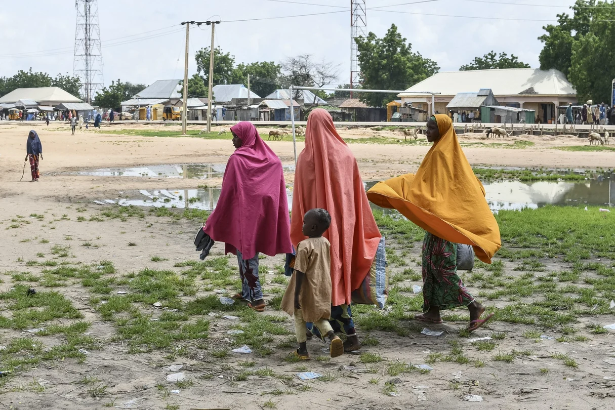Survivors and relatives of victims of a suspected Boko Haram attack walk in Babban Gide on September 4, 2024. At least 81 people died and several remain missing after an attack by presumed Boko Haram jihadists in Yobe State, northeastern Nigeria, local officials reported on September 3, 2024.