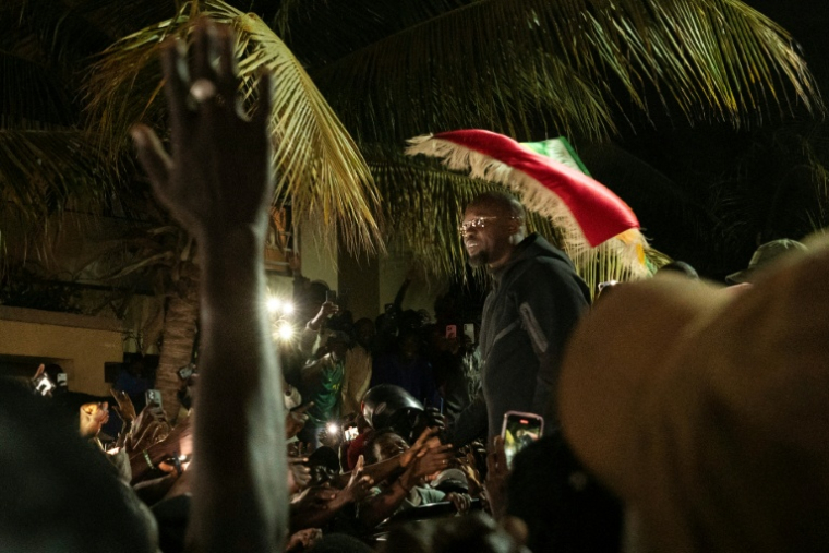 Supporters of Ousmane Sonko gathered outside his home in Dakar following his dismissal