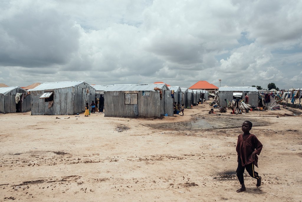 A child walks past shelters in a displacement camp in Maiduguri, Borno State, northeastern Nigeria.
