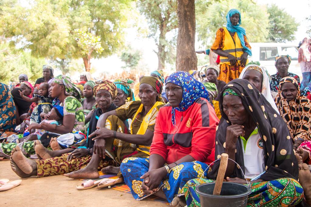 Local women and children in Yagoua, Cameroon, participate in a community awareness event for the PULCCA project, aimed at combating food insecurity and strengthening resilience.