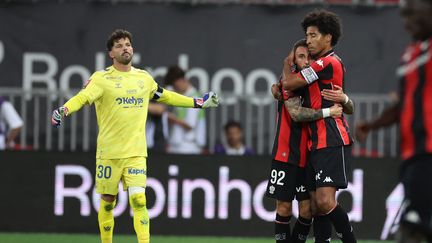 Nice players Jonathan Clauss and Dante celebrate after Dante scores in the Ligue 1/Ligue 2 playoff against Saint-Etienne on May 29.