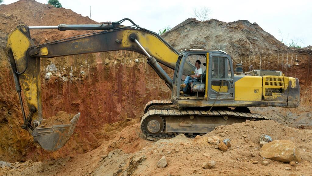 A Chinese employee operating a bulldozer at a gold mining site in Betare Oya, Cameroon, April 4, 2018.