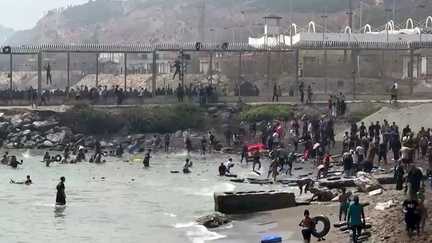 Migrants arriving on the coast of the Spanish enclave of Ceuta after swimming past the border fence between Morocco and Spain on July 30, 2026
