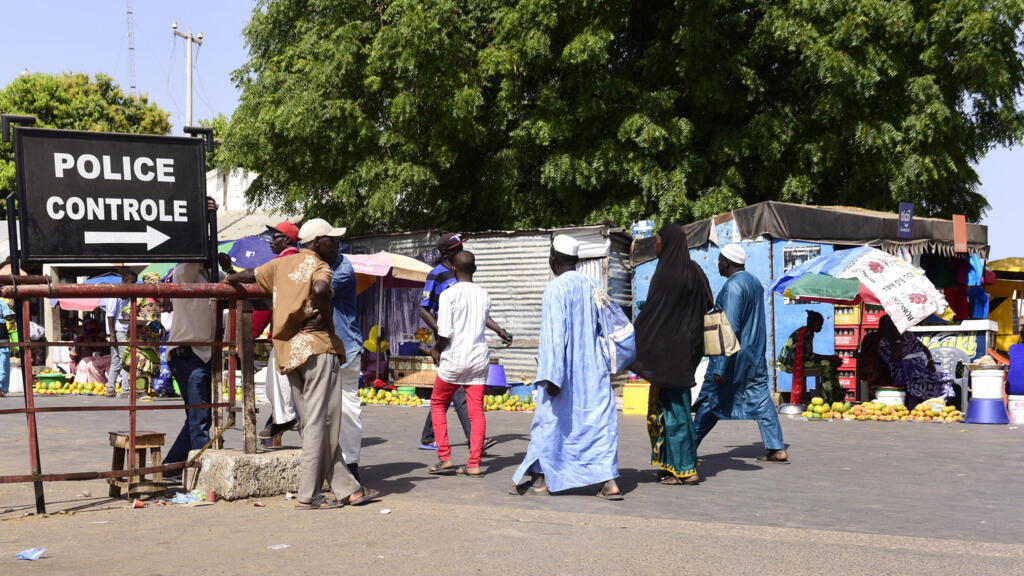 At Karang, Senegal, travelers pass through police checks to enter Gambia on May 10, 2016.