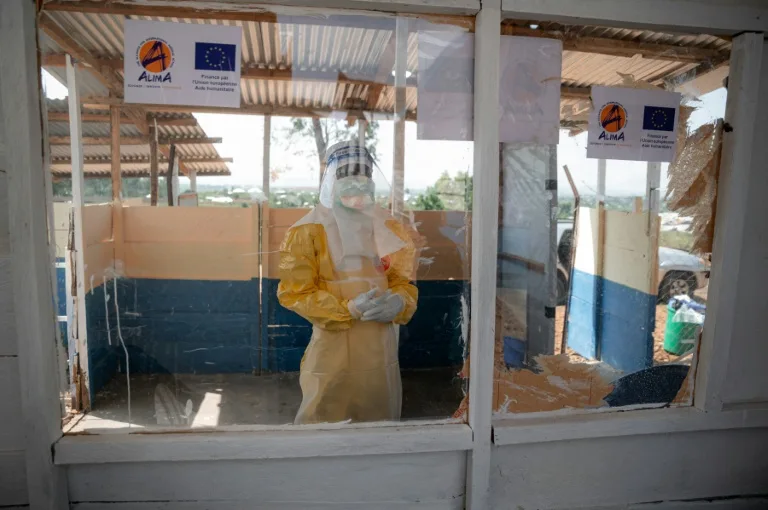 Health workers in protective gear attending to Ebola patients in a DRC treatment center